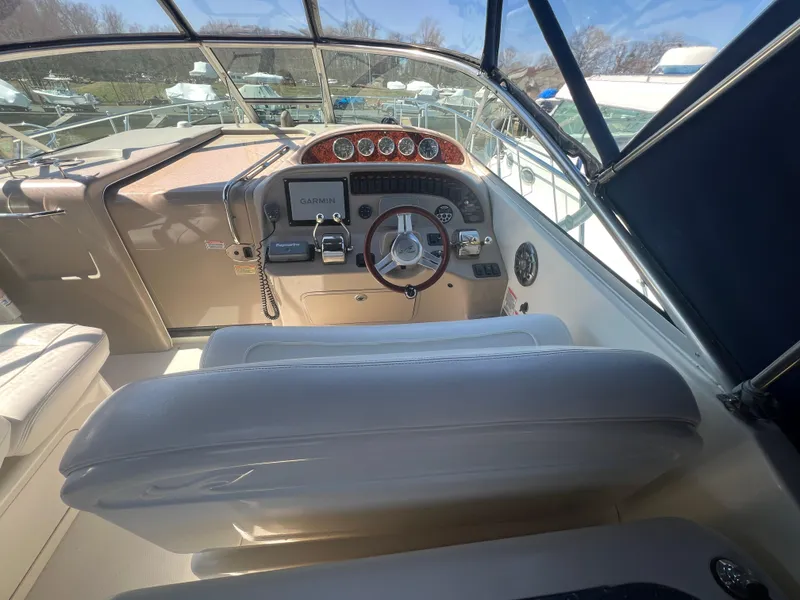 Slide: The Image of 2005 Sea Ray 290 Amberjack helm with steering wheel, gauges, and Garmin navigation system. - 8