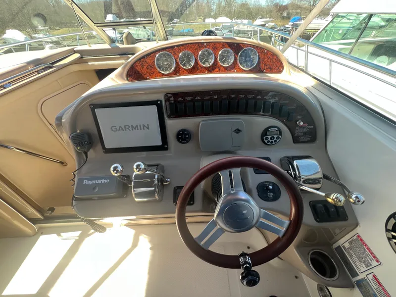 Slide: The Image of 2005 Sea Ray 290 Amberjack helm with Garmin navigation and Raymarine controls. - 9