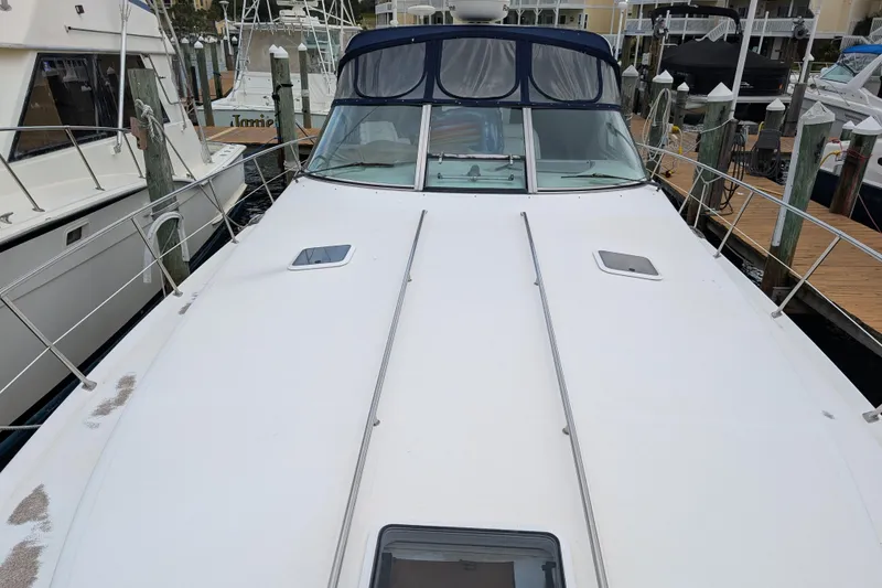 Slide: The Image of 1998 Sea Ray 400 Sundancer yacht docked at marina, view from bow. - 11