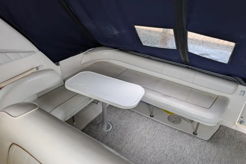 Slide: The Image of Interior seating area of a 1998 Sea Ray 400 Sundancer yacht with table. - 12