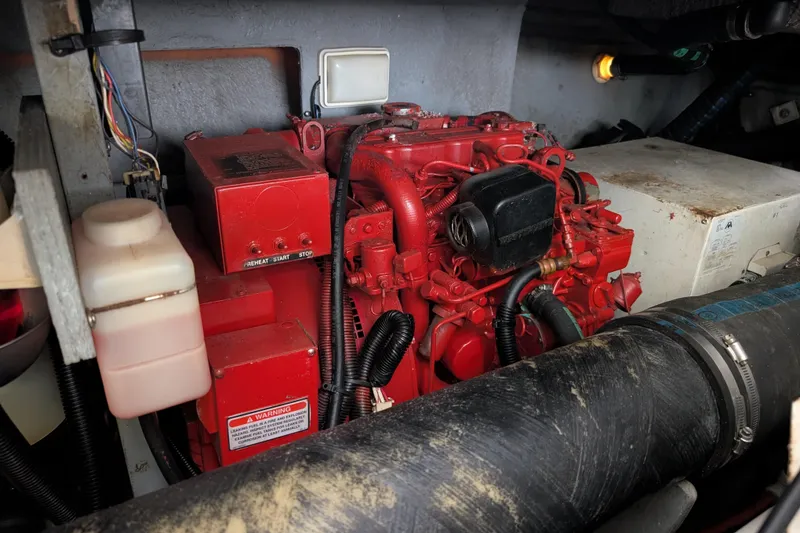 Slide: The Image of Engine compartment of a 1998 Sea Ray 400 Sundancer, featuring a red marine engine. - 14