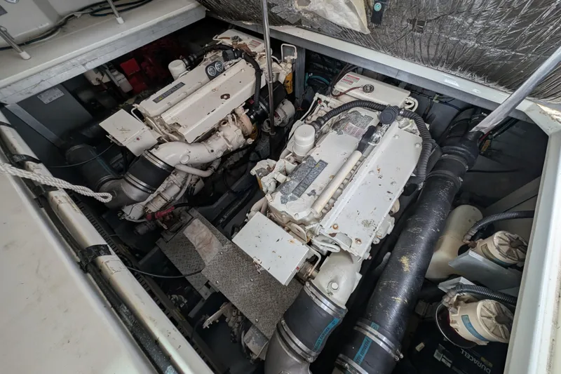 Slide: The Image of Engine room of 1998 Sea Ray 400 Sundancer with dual engines and mechanical components. - 15