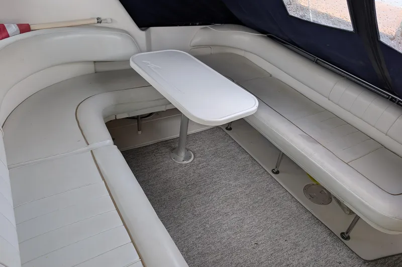 Slide: The Image of 1998 Sea Ray 400 Sundancer interior with white seating and table. - 18