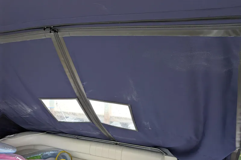 Slide: The Image of 1998 Sea Ray 400 Sundancer interior with blue canvas cover and windows. - 20