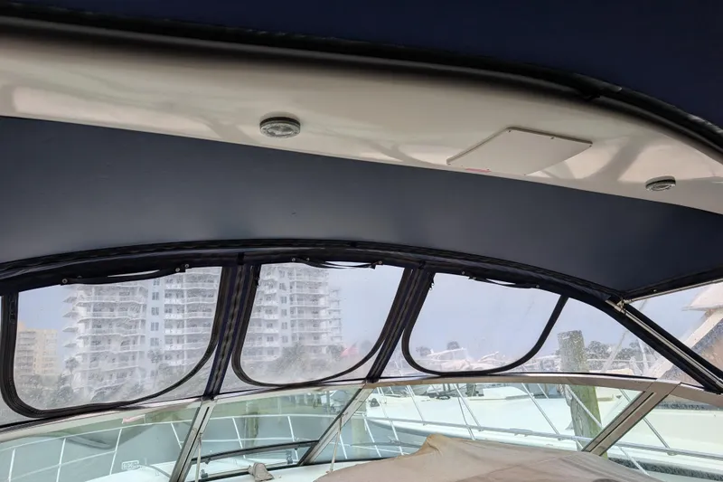 Slide: The Image of Interior view of 1998 Sea Ray 400 Sundancer yacht with cityscape background. - 21