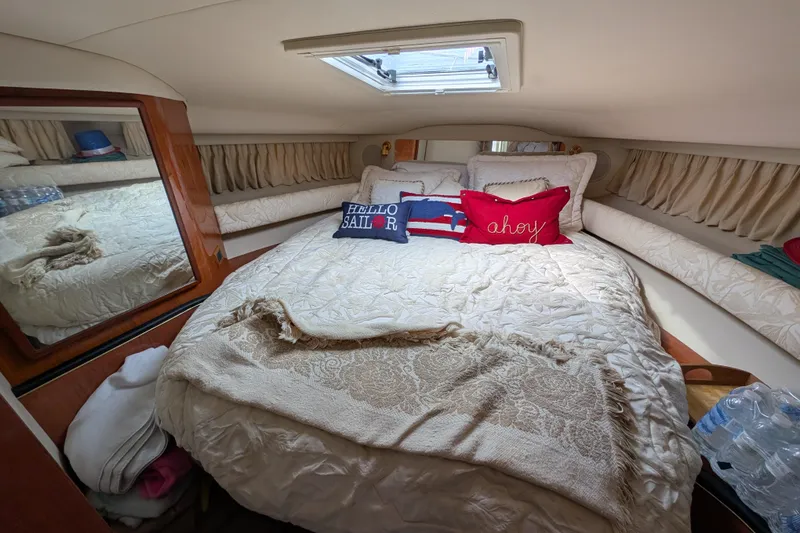 Slide: The Image of Cozy bedroom in 1998 Sea Ray 400 Sundancer yacht with nautical-themed pillows. - 24