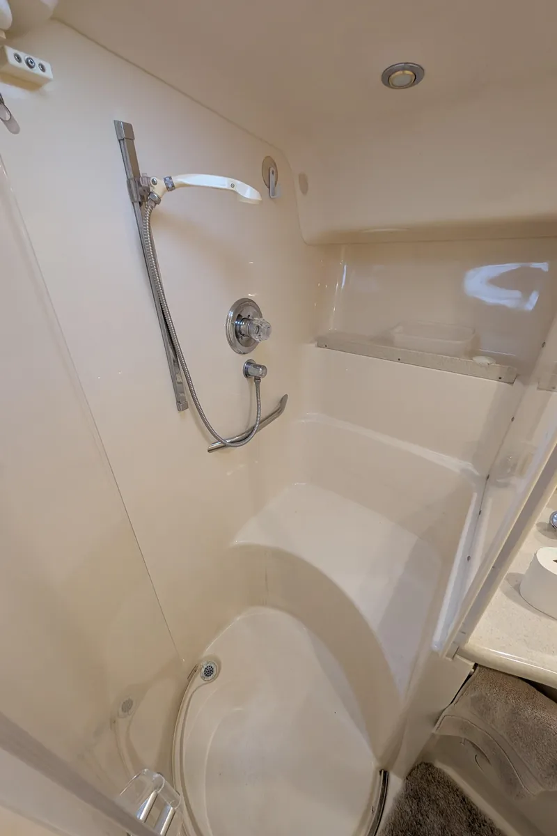 Slide: The Image of 1998 Sea Ray 400 Sundancer bathroom with shower and modern fixtures. - 25