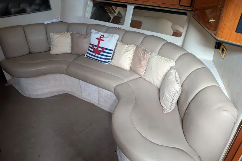 Slide: The Image of Luxurious interior of 1998 Sea Ray 400 Sundancer with plush seating and nautical-themed decor. - 26