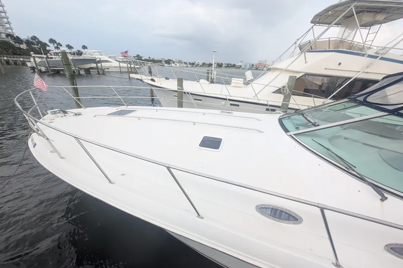 Slide: The Image of 1998 Sea Ray 400 Sundancer yacht docked at marina, side view. - 3