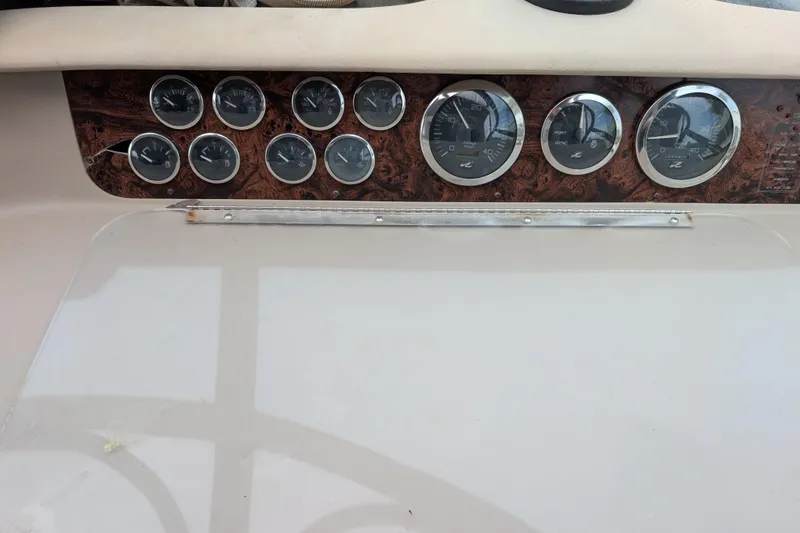 Slide: The Image of Dashboard of a 1998 Sea Ray 400 Sundancer with multiple gauges and wood paneling. - 32