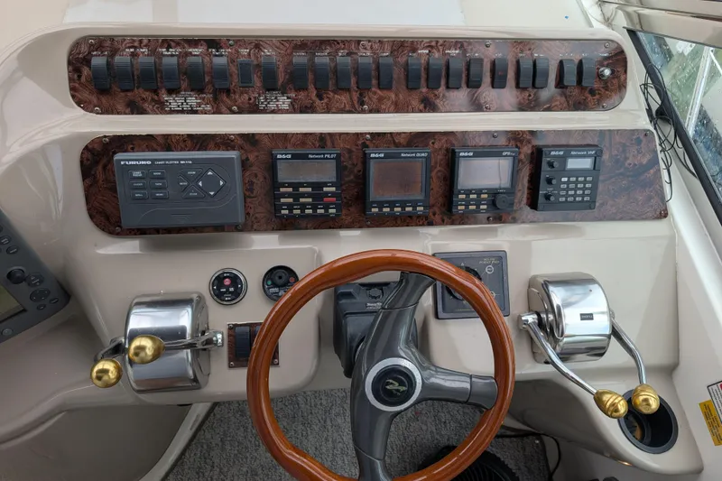 Slide: The Image of Control panel of a 1998 Sea Ray 400 Sundancer boat with steering wheel and gauges. - 33
