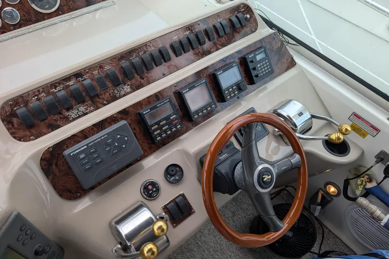Slide: The Image of Control panel of a 1998 Sea Ray 400 Sundancer boat with wooden steering wheel. - 34