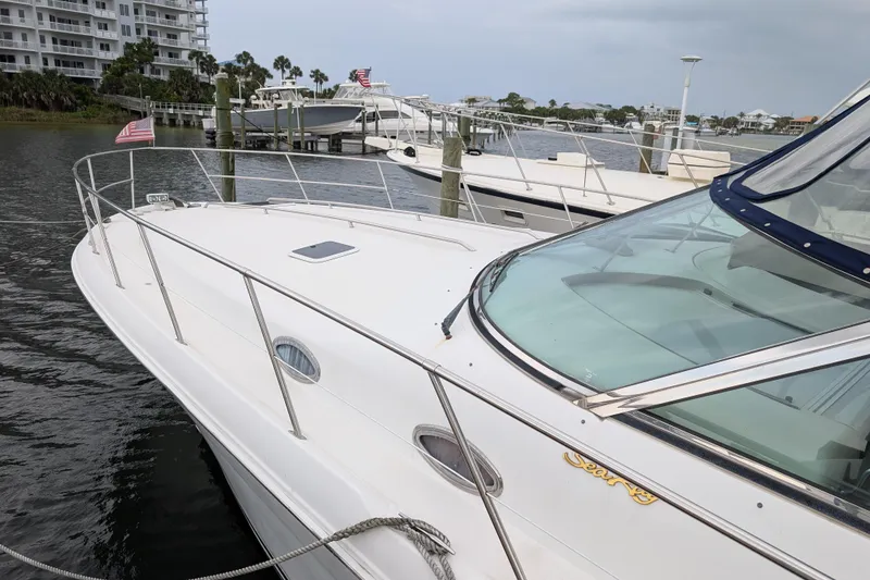 Slide: The Image of 1998 Sea Ray 400 Sundancer yacht docked at marina, featuring sleek design and spacious deck. - 4