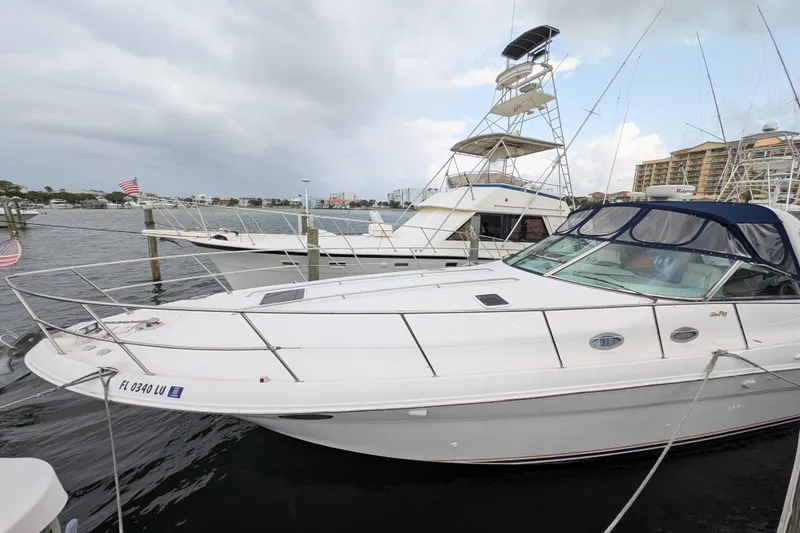 Slide: The Image of 1998 Sea Ray 400 Sundancer yacht docked at marina, overcast sky. - 5