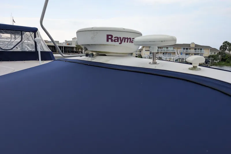 Slide: The Image of Radar equipment on a 1998 Sea Ray 400 Sundancer yacht, docked near waterfront homes. - 7