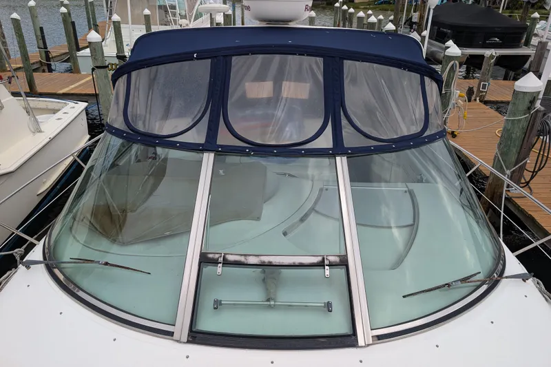 Slide: The Image of 1998 Sea Ray 400 Sundancer yacht with blue canopy docked at marina. - 8