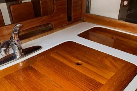 Slide: The Image of Wooden countertop with sink and faucet on a 1986 Cabo Rico CB38 yacht. - 16