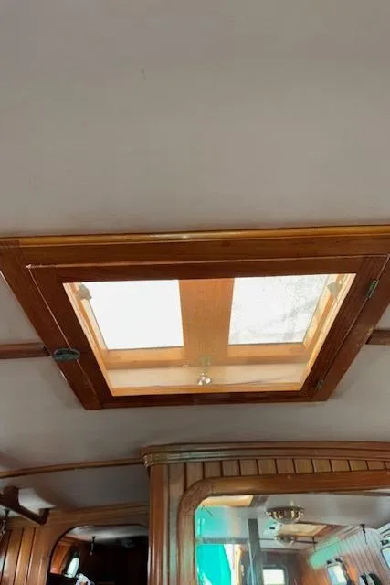 Slide: The Image of 1986 Cabo Rico CB38 interior with wooden hatch and ceiling details. - 19