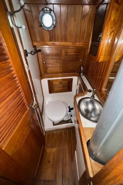 Slide: The Image of 1986 Cabo Rico CB38 yacht bathroom with wooden interior and stainless steel sink. - 25
