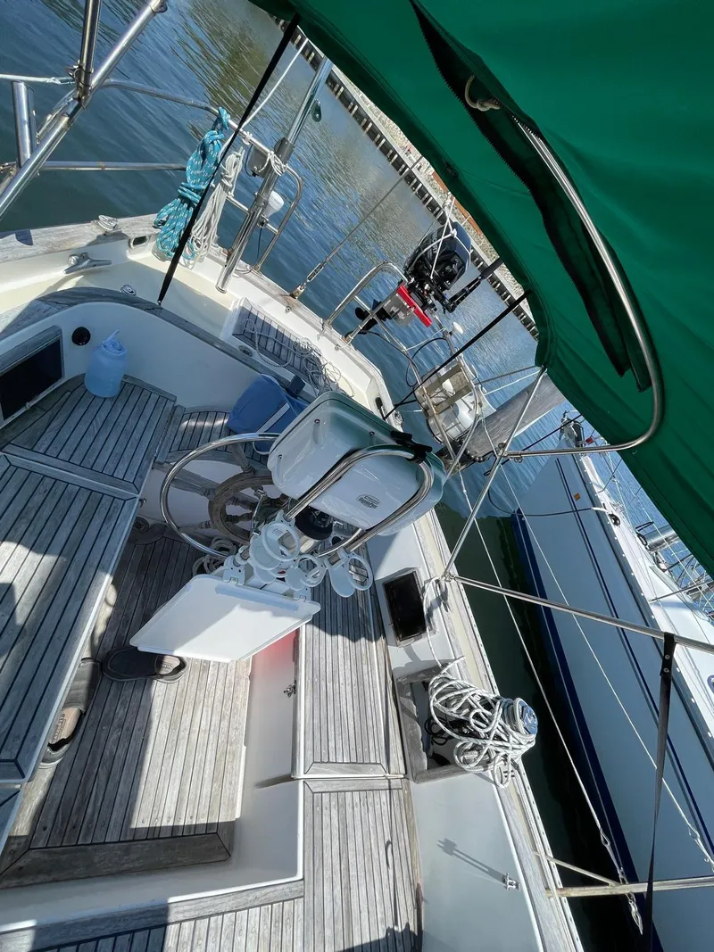 Slide: The Image of 1986 Cabo Rico CB38 sailboat cockpit with green canopy and wooden deck. - 4