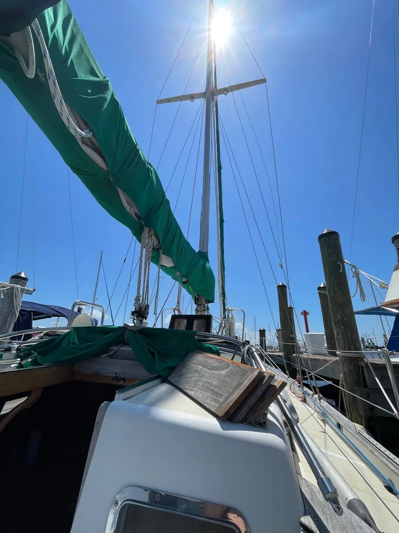 Slide: The Image of 1986 Cabo Rico CB38 sailboat docked under clear blue sky. - 5