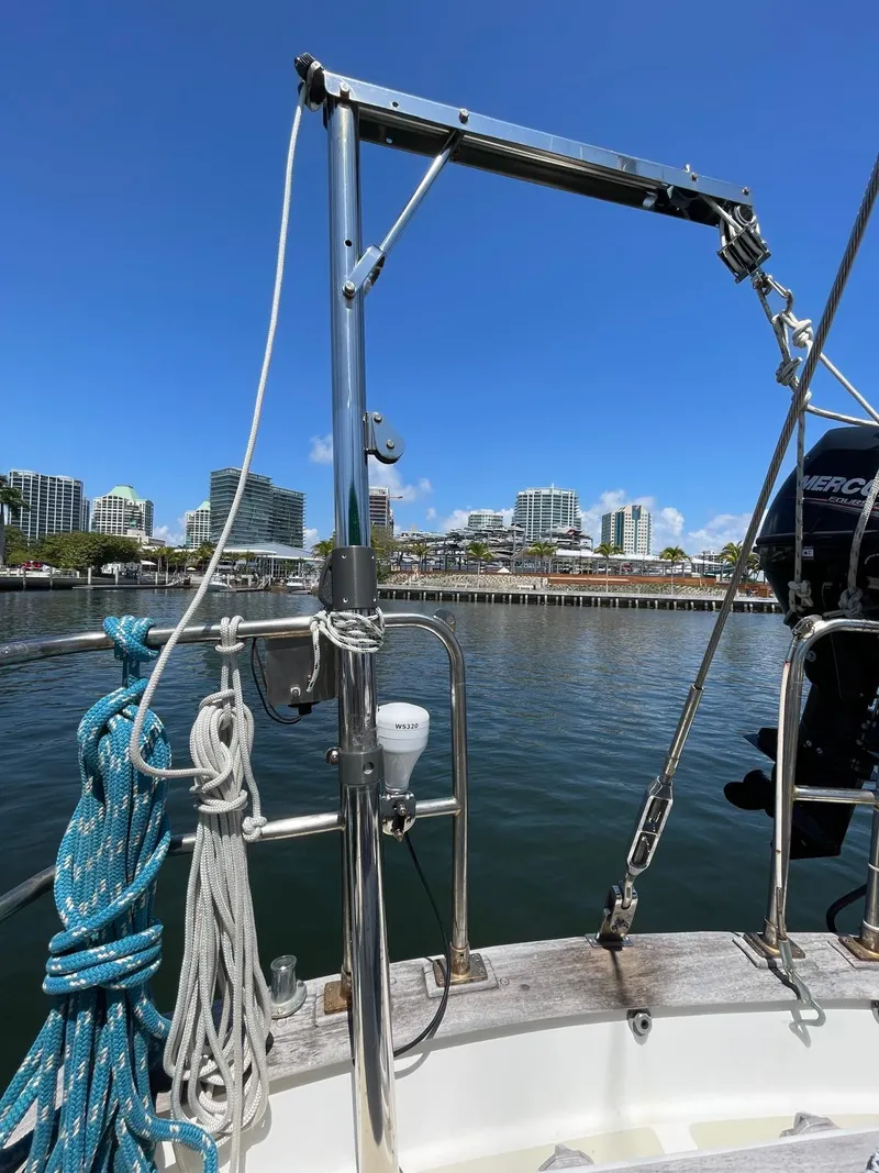 Slide: The Image of 1986 Cabo Rico CB38 sailboat docked with city skyline in background. - 6