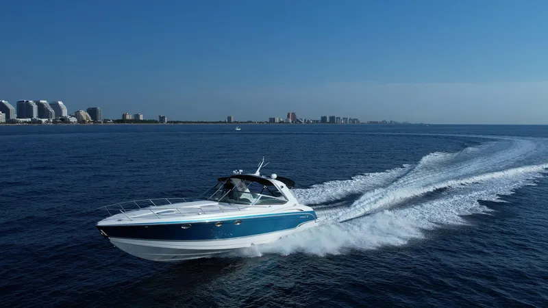 The Image of 2006 Formula 400 Super Sport boat cruising on open water near a city skyline. - 0
