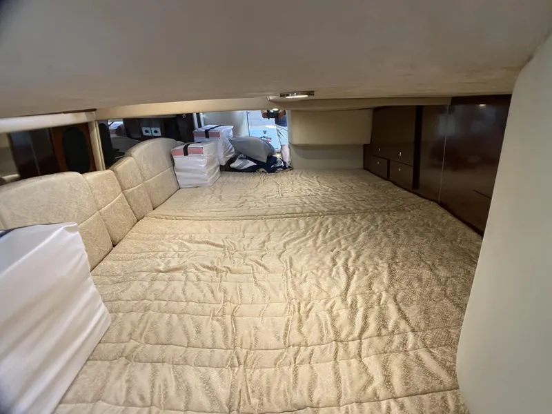 Slide: The Image of Interior cabin of 2006 Formula 400 Super Sport with beige bedding and storage. - 14