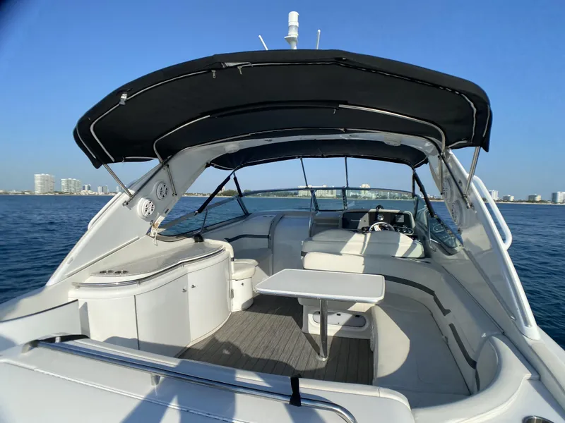 Slide: The Image of 2006 Formula 400 Super Sport boat interior with seating and table, under a black canopy on open water. - 36
