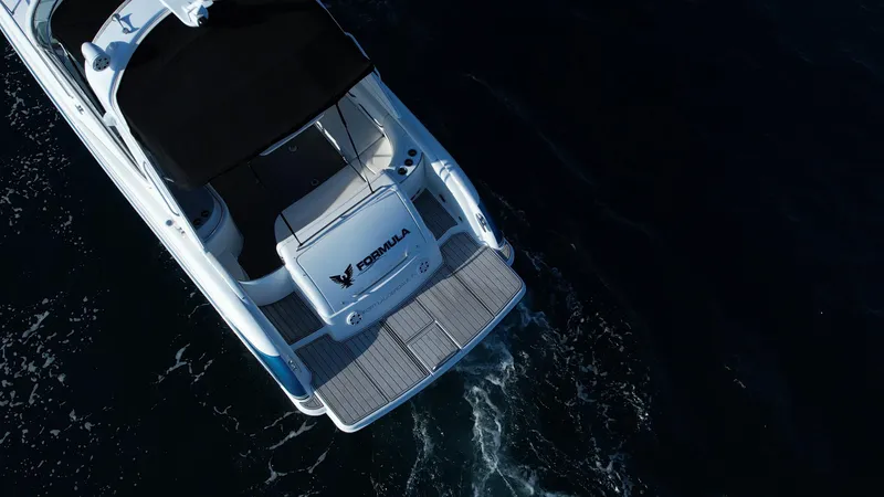 Slide: The Image of 2006 Formula 400 Super Sport boat cruising on dark water, aerial view. - 7