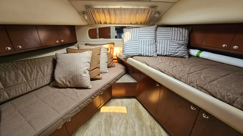 Slide: The Image of Luxurious interior of 2007 Sea Ray 40 Motor Yacht with cozy bedding and wooden cabinetry. - 17