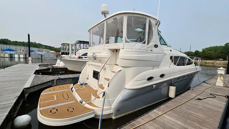 Slide: The Image of 2007 Sea Ray 40 Motor Yacht docked at marina, featuring spacious deck and sleek design. - 2