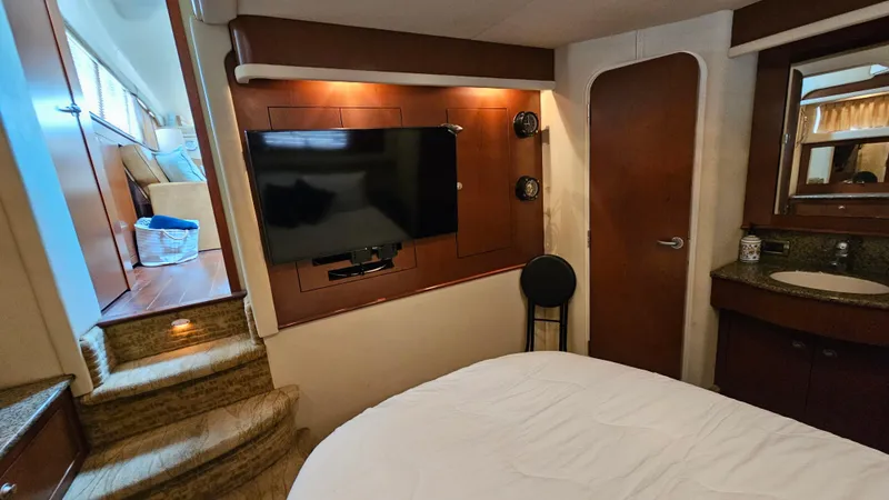 Slide: The Image of Luxurious 2007 Sea Ray 40 Motor Yacht bedroom with TV and elegant wood finishes. - 24