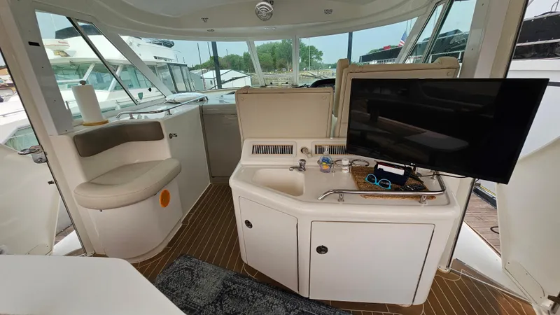 Slide: The Image of 2007 Sea Ray 40 Motor Yacht interior with seating, sink, and TV. - 8