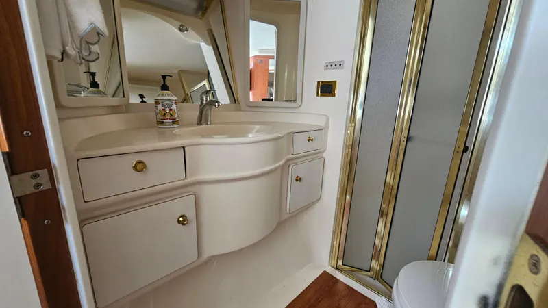 Slide: The Image of Bathroom interior of 1999 Sea Ray 500 Sundancer yacht with sink and shower. - 30