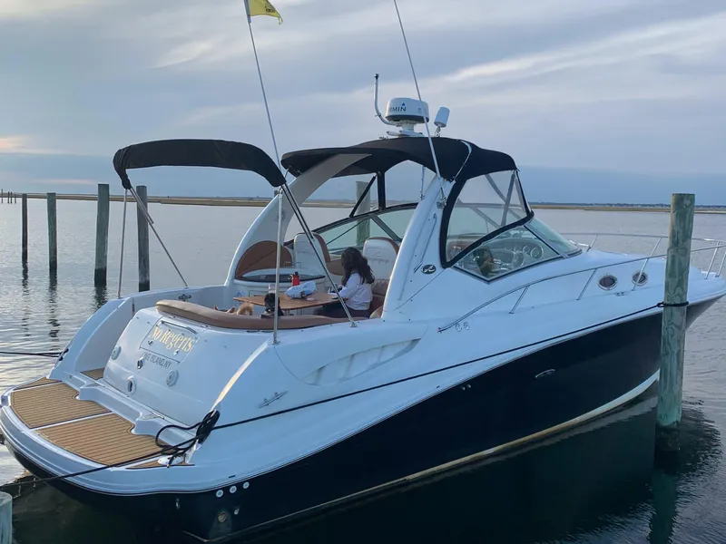 The Image of 2003 Sea Ray 340 Sundancer docked, featuring sleek design and spacious deck. - 0