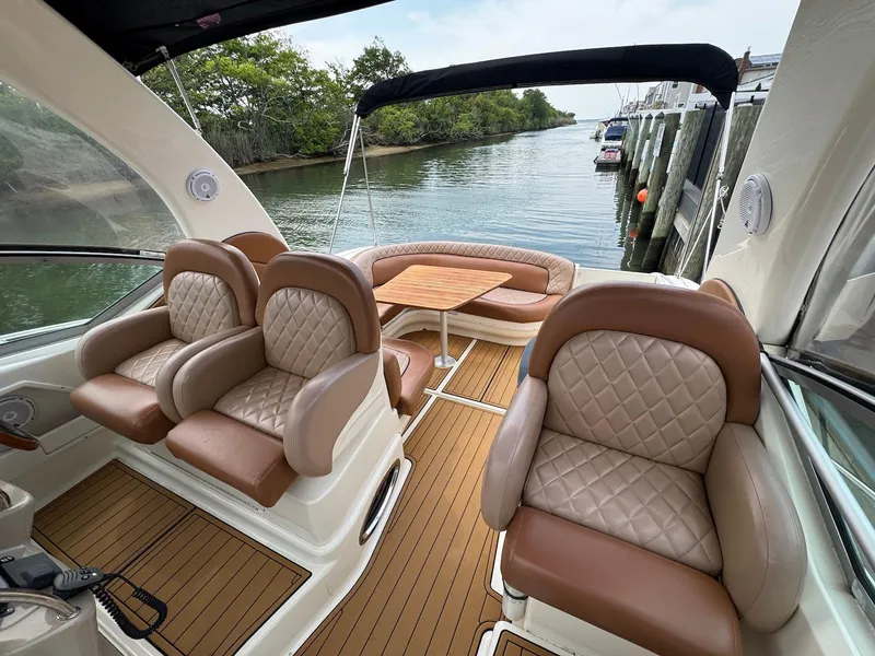 Slide: The Image of Luxurious 2003 Sea Ray 340 Sundancer interior with plush seating and scenic waterway view. - 13