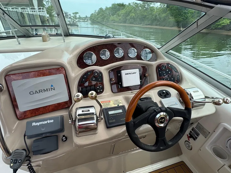 Slide: The Image of 2003 Sea Ray 340 Sundancer helm with Garmin and Raymarine navigation systems. - 14