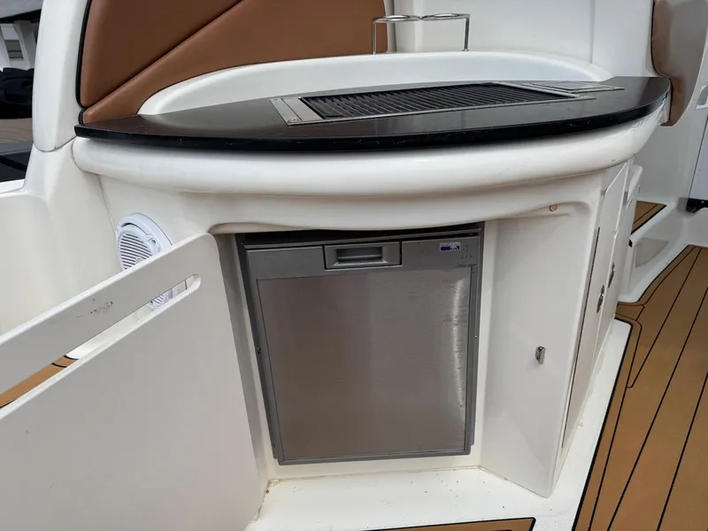 Slide: The Image of 2003 Sea Ray 340 Sundancer boat kitchenette with mini fridge and countertop. - 15