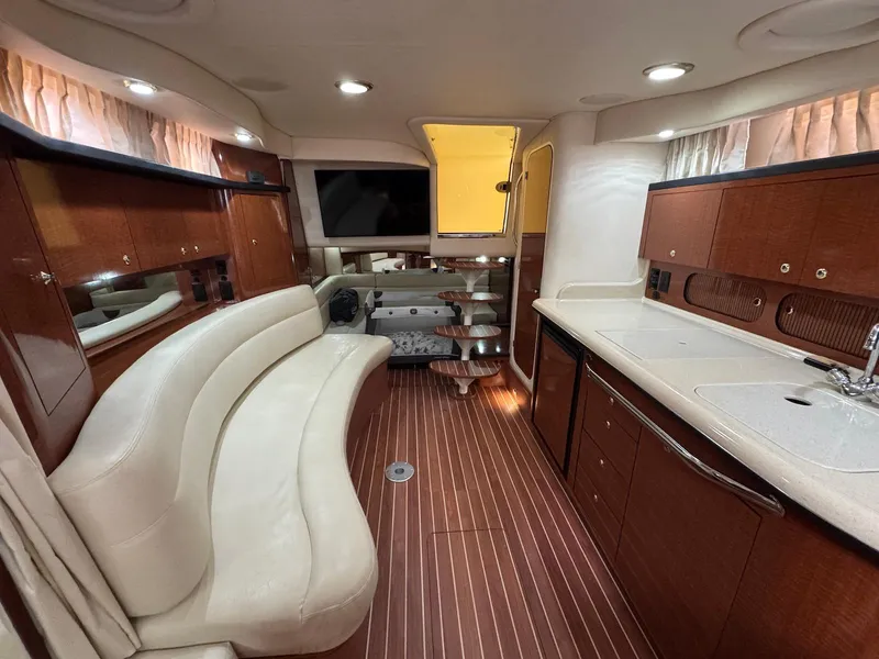 Slide: The Image of Luxurious interior of 2003 Sea Ray 340 Sundancer yacht with elegant seating and kitchenette. - 22