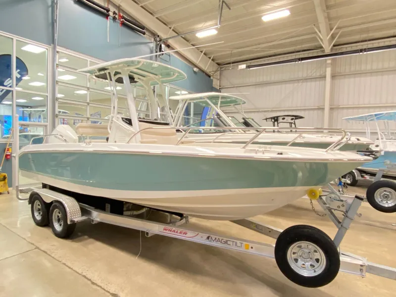 Slide: The Image of 2022 Boston Whaler 220 Dauntless boat on trailer in showroom. - 13