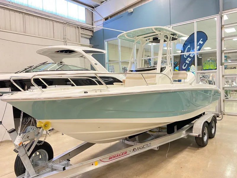 Slide: The Image of 2022 Boston Whaler 220 Dauntless boat on trailer in showroom setting. - 15