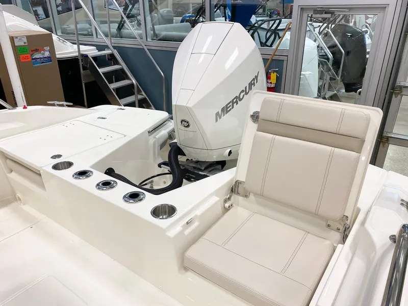 Slide: The Image of 2022 Boston Whaler 220 Dauntless boat interior with Mercury engine and seating. - 18