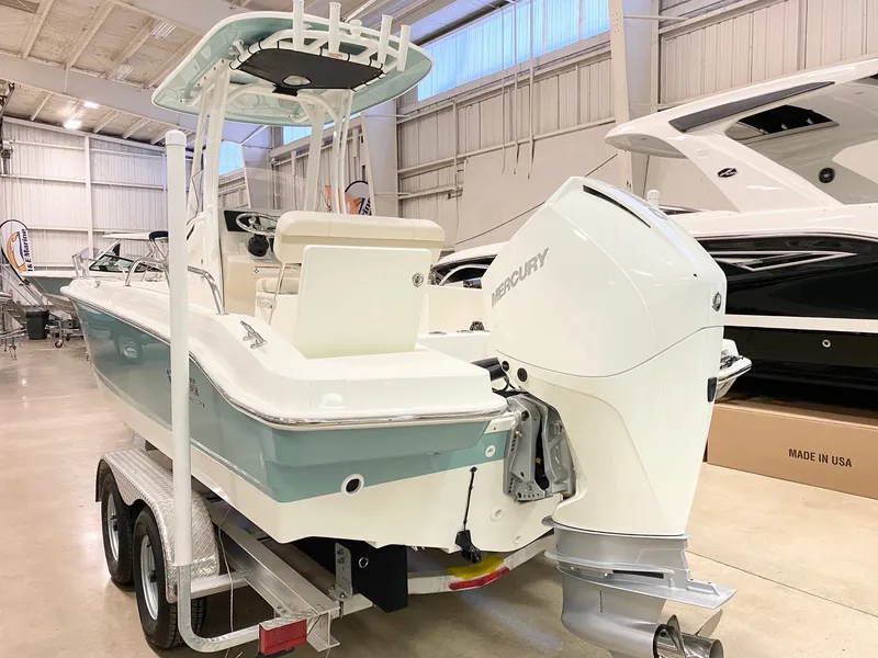 Slide: The Image of 2022 Boston Whaler 220 Dauntless boat on trailer in indoor showroom. - 19