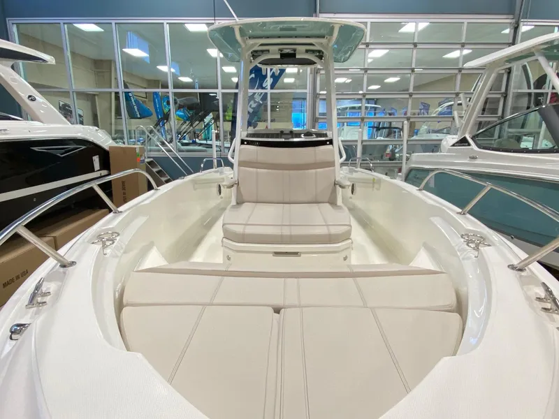 Slide: The Image of 2022 Boston Whaler 220 Dauntless boat interior with cushioned seating and sleek design. - 22