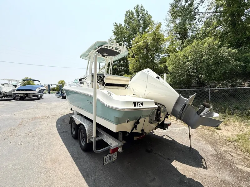 Slide: The Image of 2022 Boston Whaler 220 Dauntless boat on trailer, parked outdoors. - 4