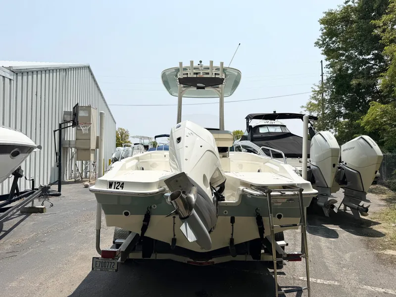 Slide: The Image of 2022 Boston Whaler 220 Dauntless boat parked outdoors near other boats. - 5