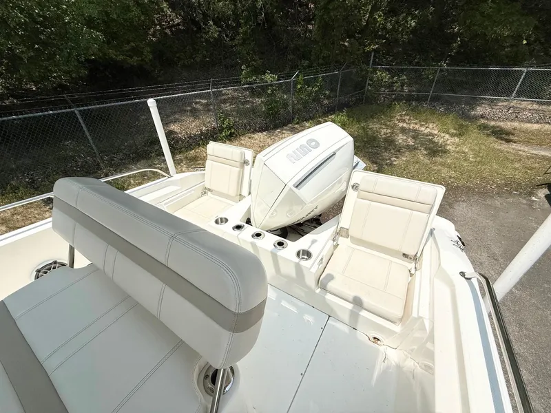 Slide: The Image of 2022 Boston Whaler 220 Dauntless boat interior with seating and engine view. - 7