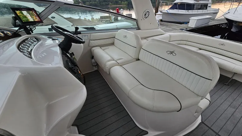 Slide: The Image of 2003 Monterey 322 Cruiser interior with white leather seating and modern dashboard. - 10