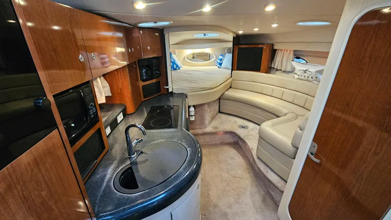 Slide: The Image of Interior of a 2003 Monterey 322 Cruiser with kitchen, seating, and sleeping area. - 13